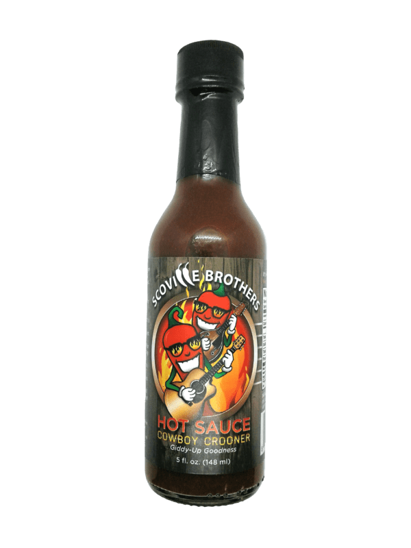 A bottle of hot sauce with a green background